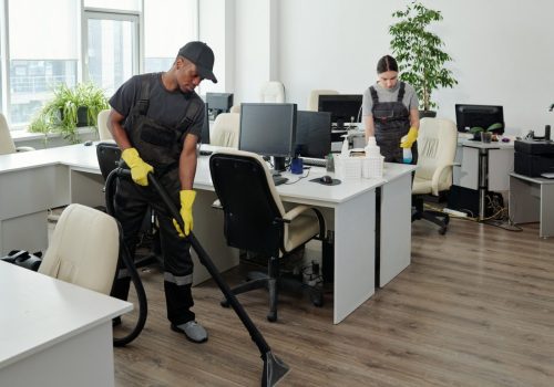 workers-of-cleaning-service-company-carrying-out-their-work-in-openspace-office.jpg